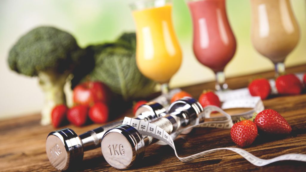 Photo of weights, vegetables, smoothies, and a measurement tape