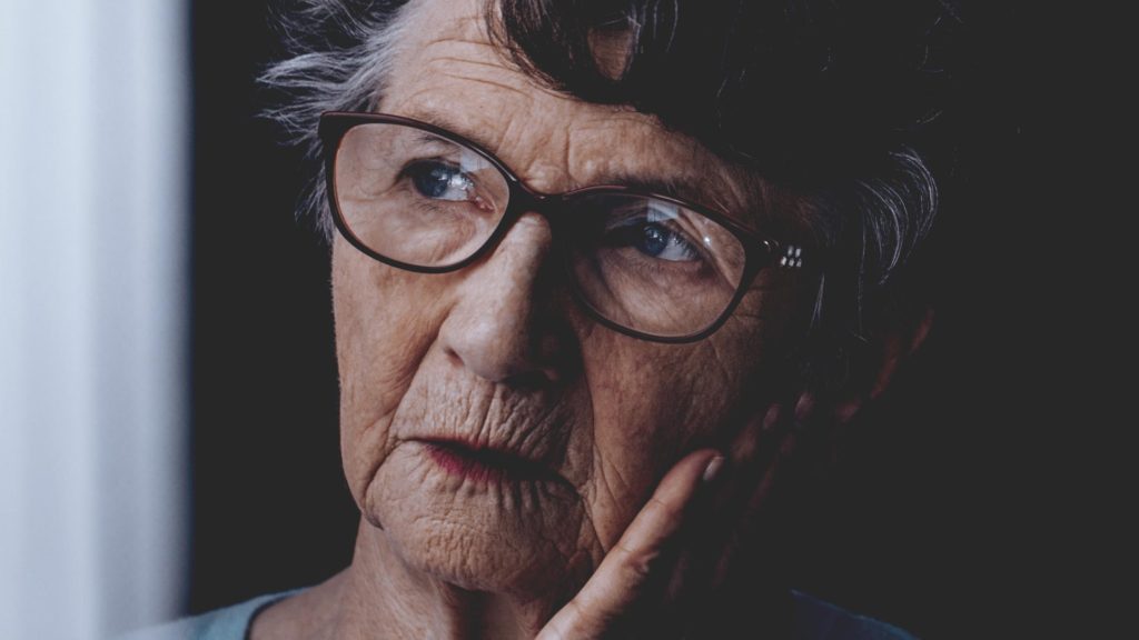 Elderly woman looking concerned and lost