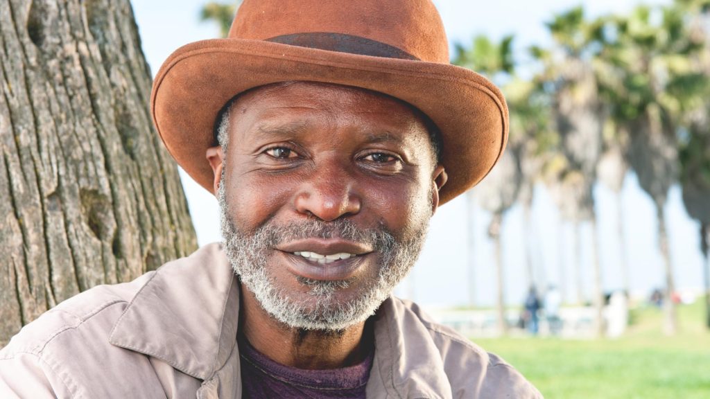 Elderly African-American male smiling outdoors