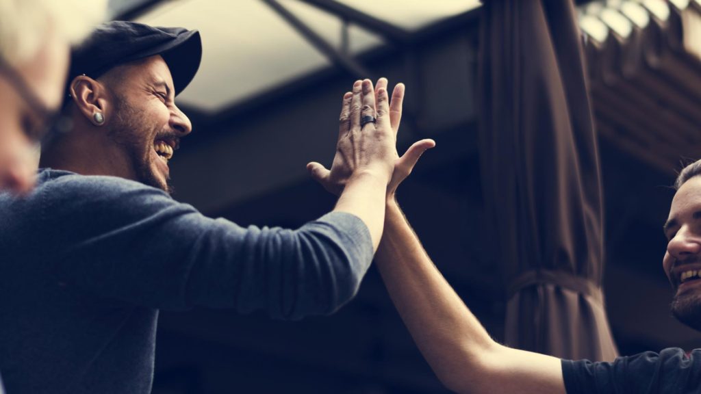 Co-workers high-fiving each other