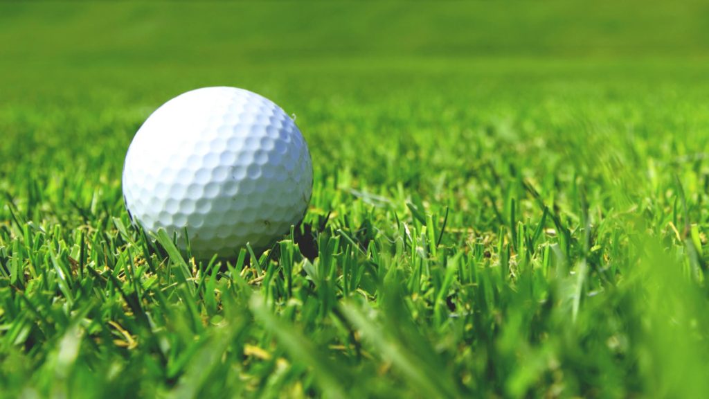 Close-up photo of a golf ball on a green