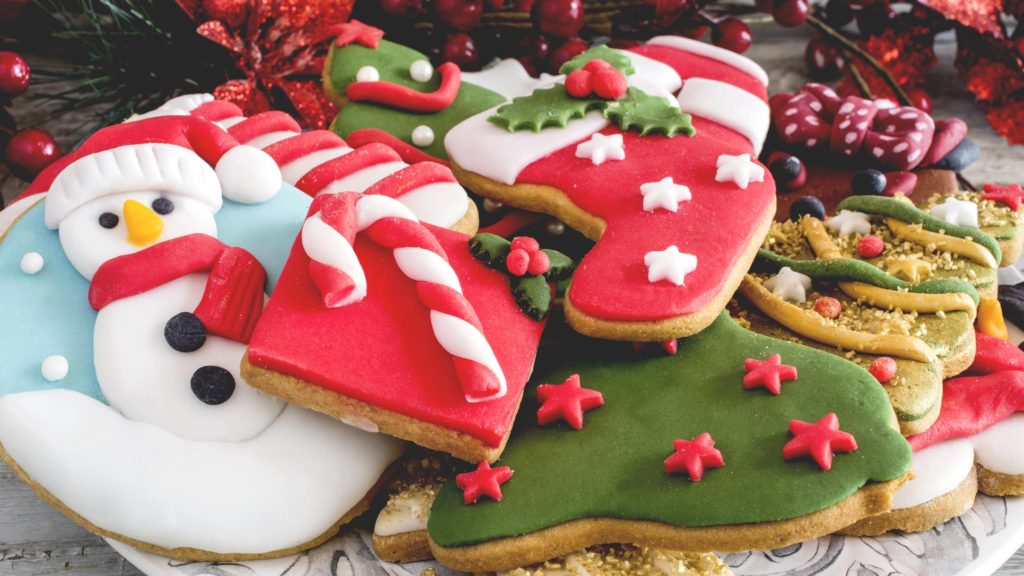 A festive display of several Christmas-decorated cookies
