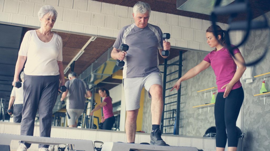 Older male and female working with a female trainer